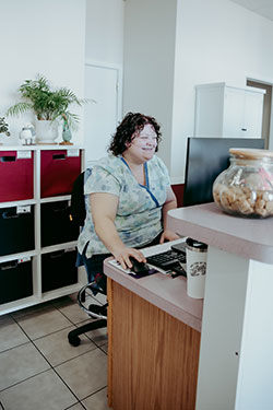 Receptionist, Sheena, greeting new clients